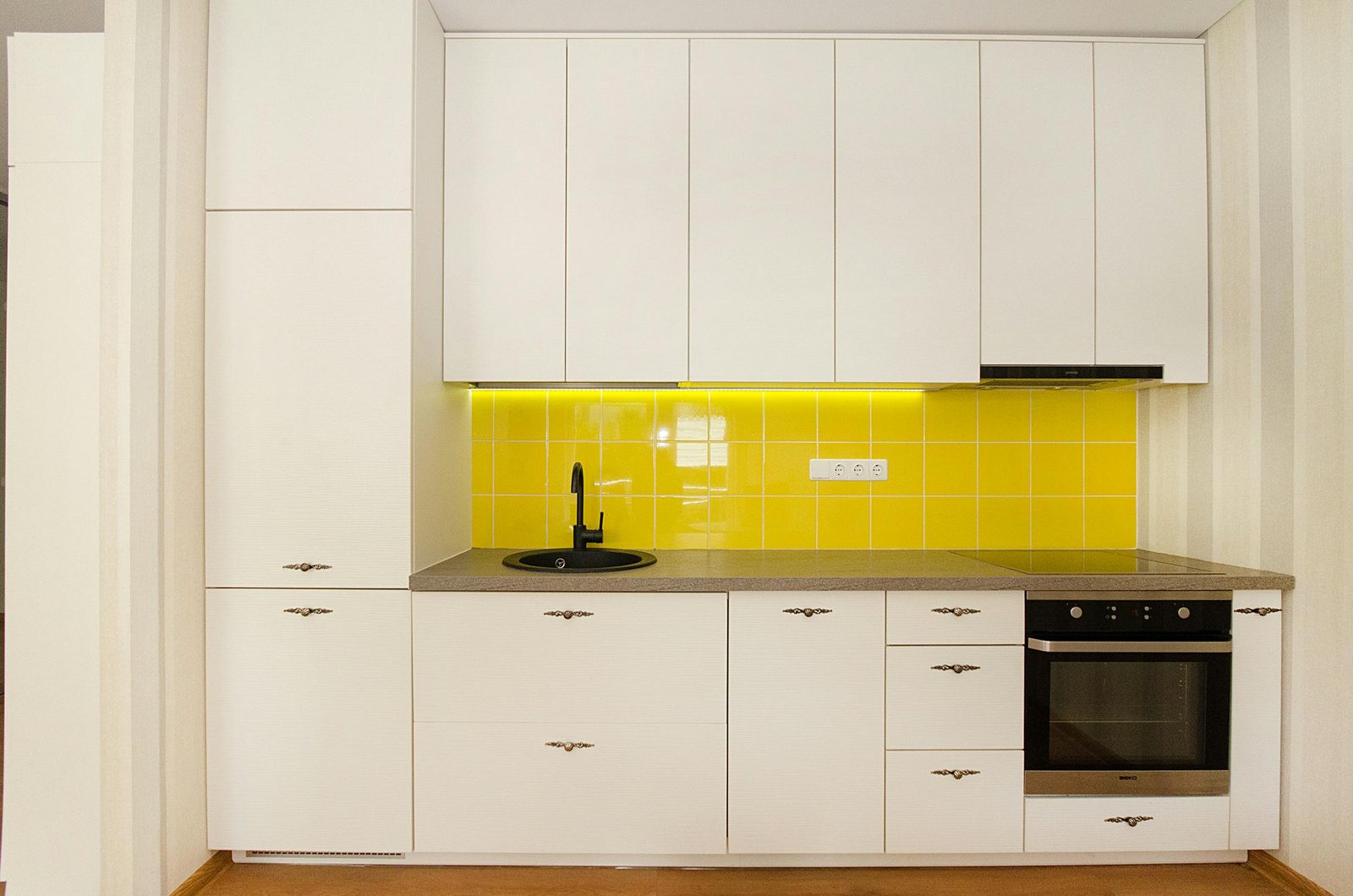 Minimal white kitchen with a yellow tile backsplash