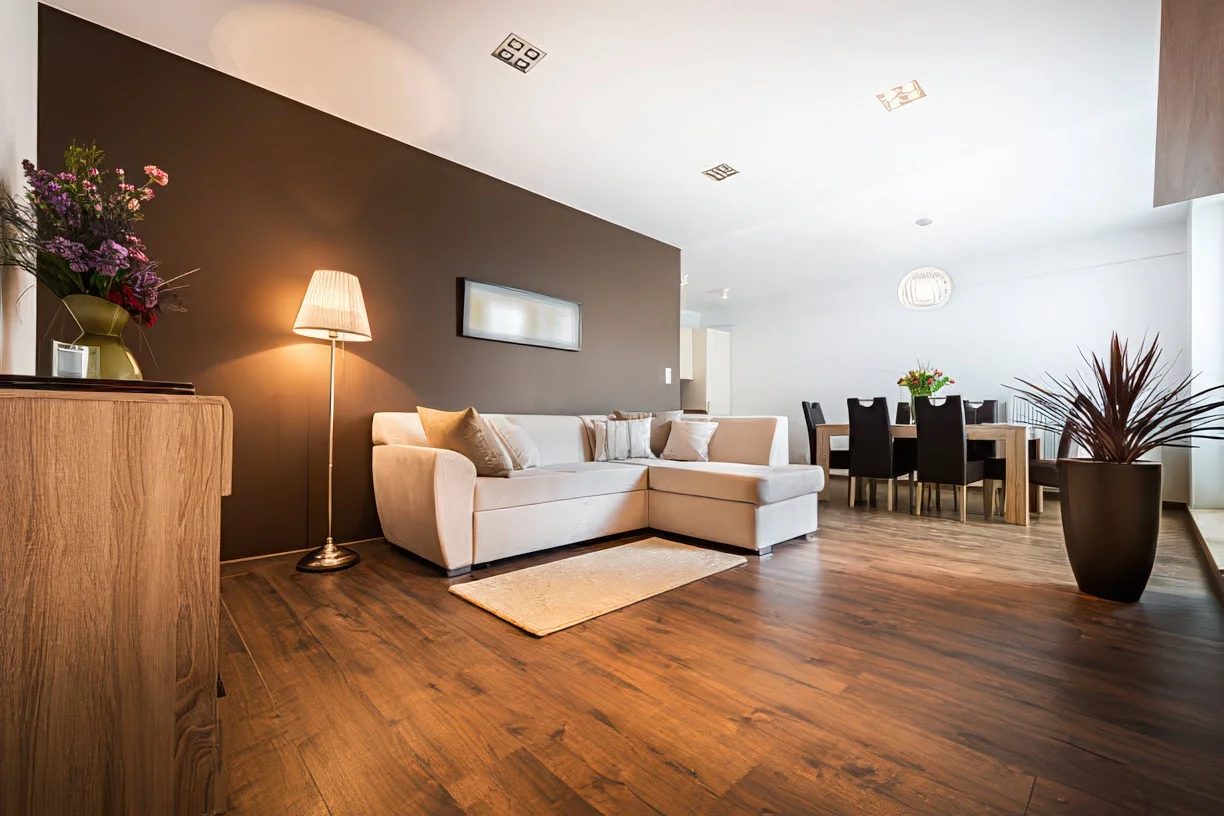 Living room with a dark accent wall and hardwood floors