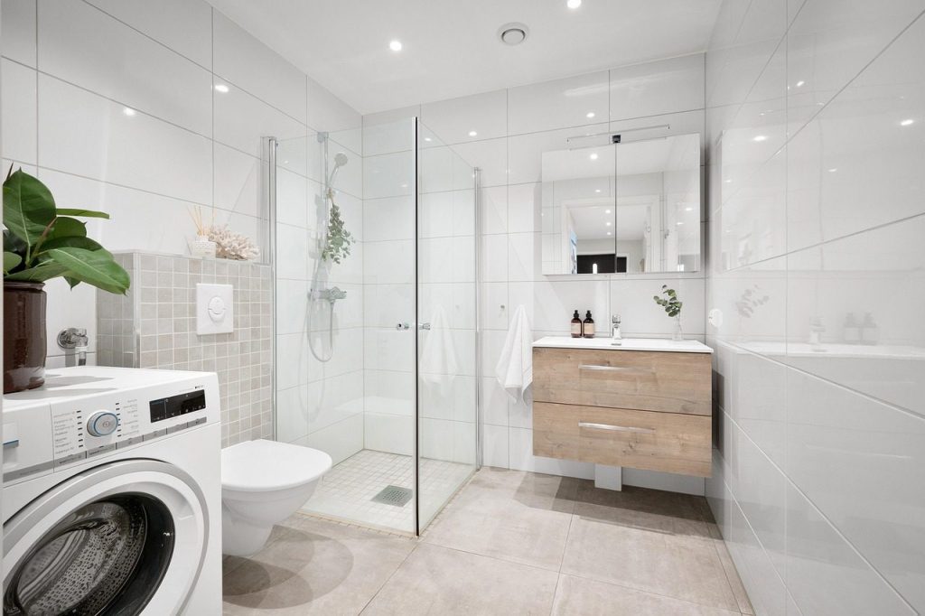 White bathroom with a glass walk-in shower
