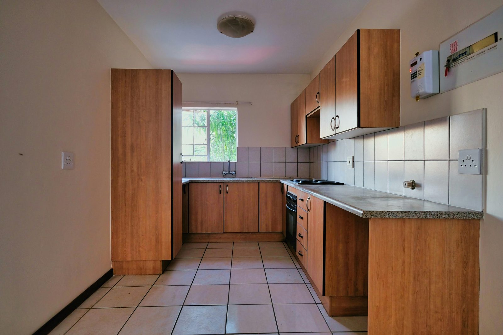 Kitchen with warm wood cabinets and tile floor
