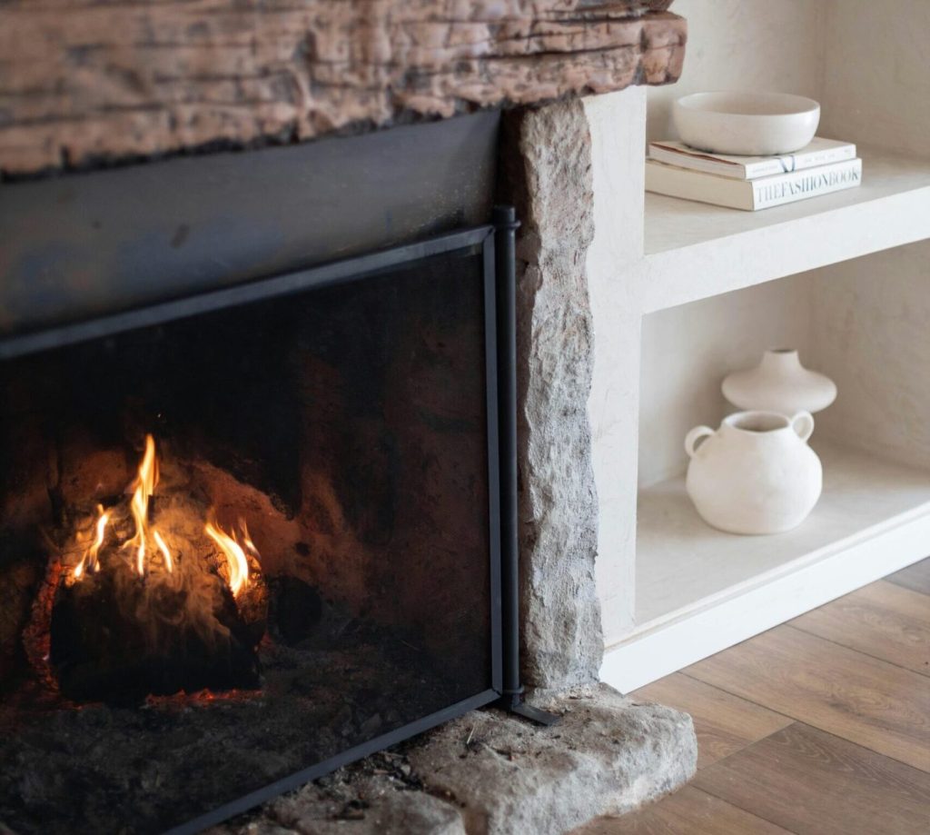 Close-up of a natural stone fireplace surround